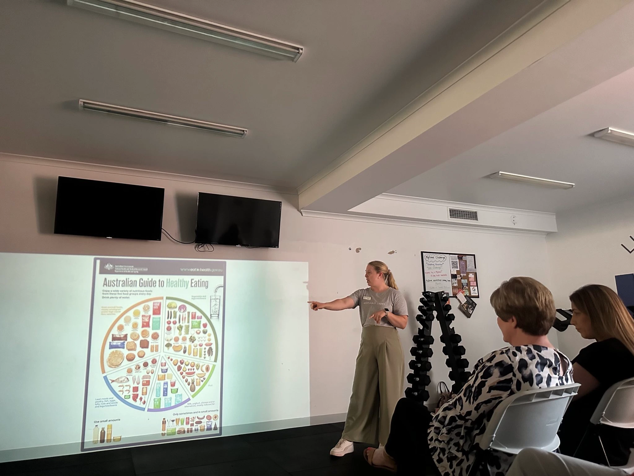 Person presenting healthy eating guide to a small group