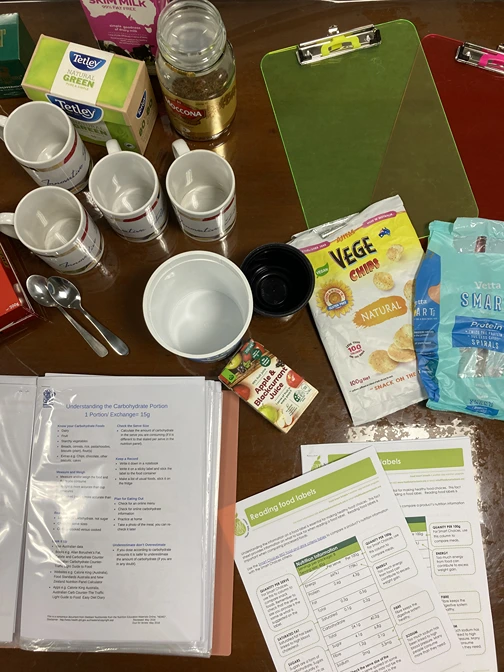 Diabetes education setup with snacks, food labels, and nutrition handouts.