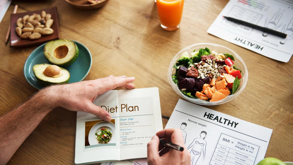 Dietitian consultation table with meal planning materials, balanced food and nutrition support resources for eating disorder care.